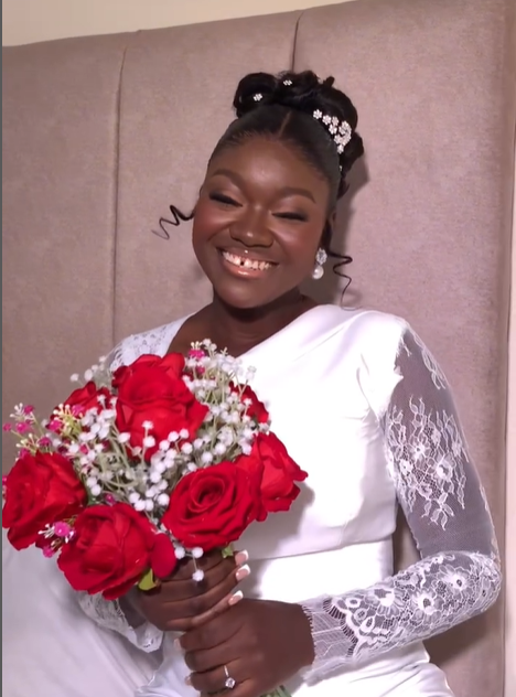 Bride holding a bouquet of red roses