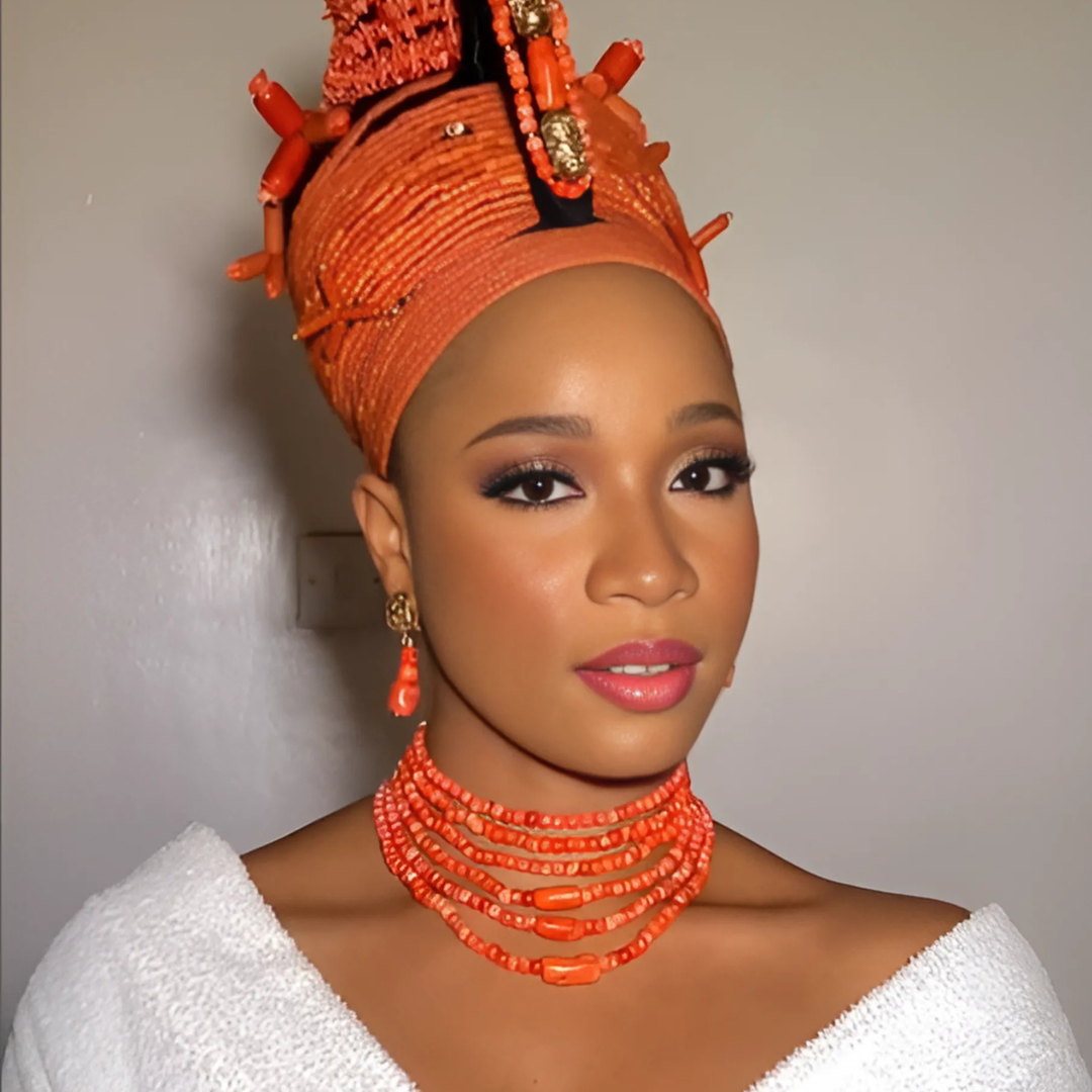 Portrait with coral beads and orange gele